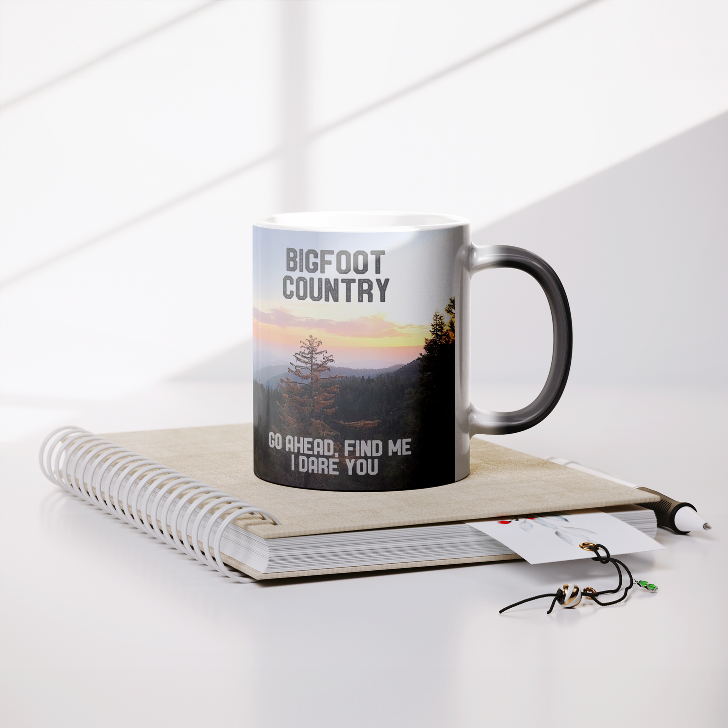 Bigfoot_Country_Magic_Mug_Lifestyle_Notebook_Mockup.png