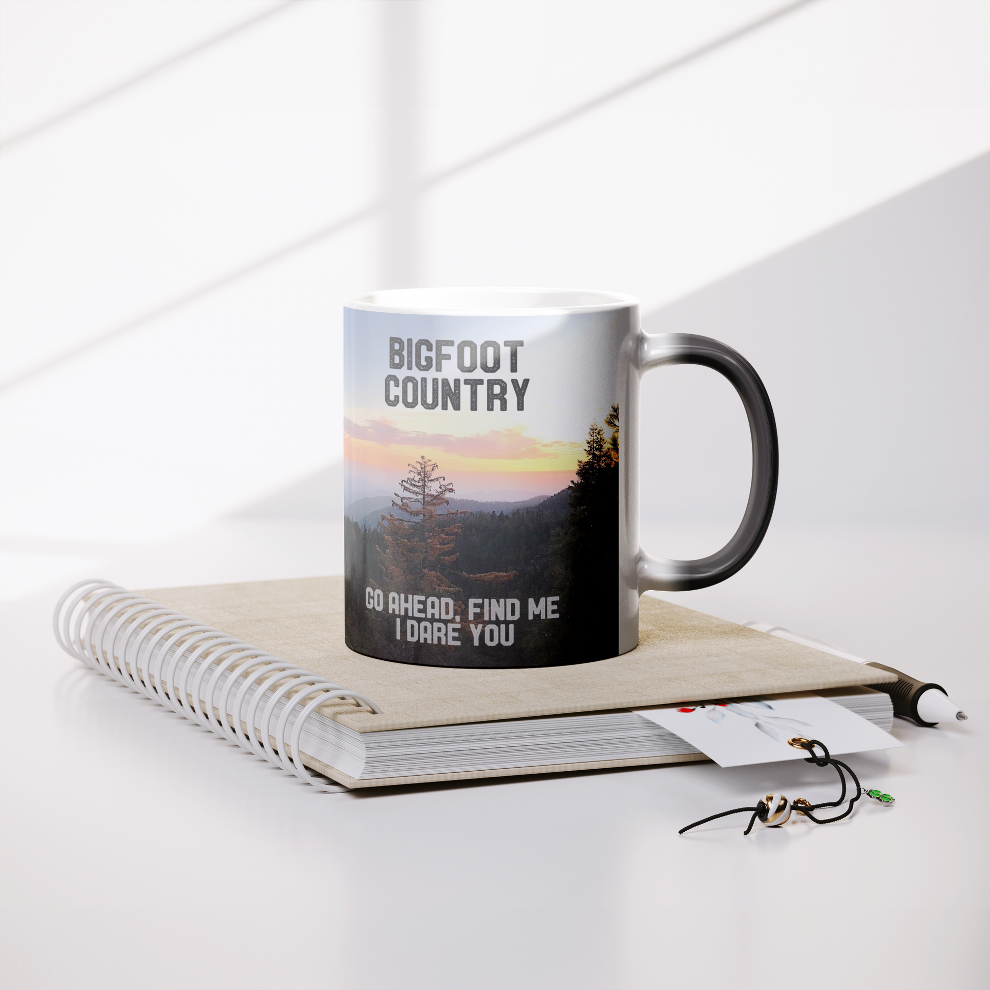 Bigfoot_Country_Magic_Mug_Lifestyle_Notebook_Mockup.png